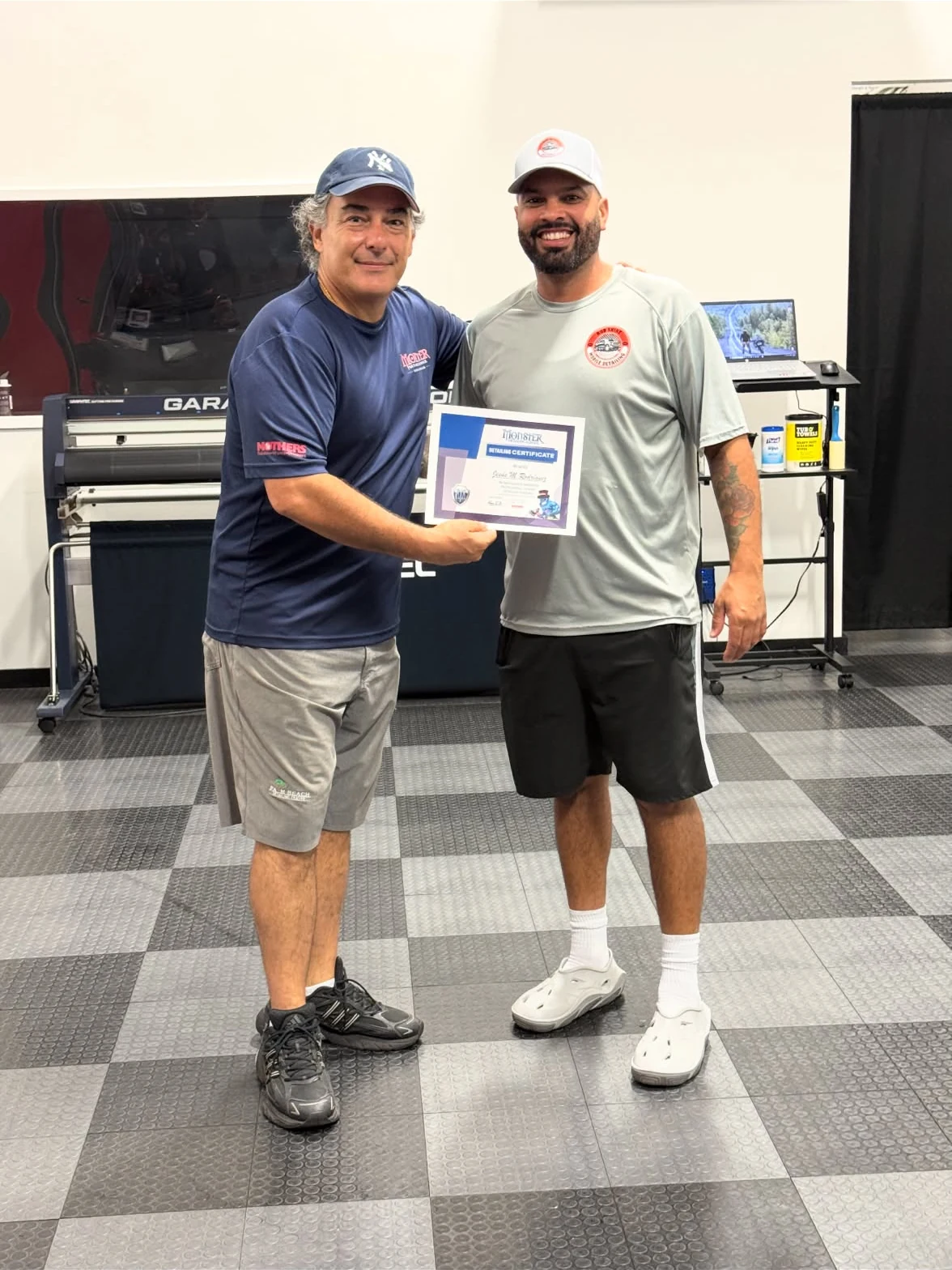 Rod Shine owner holding his detailing training certificate with his instructor