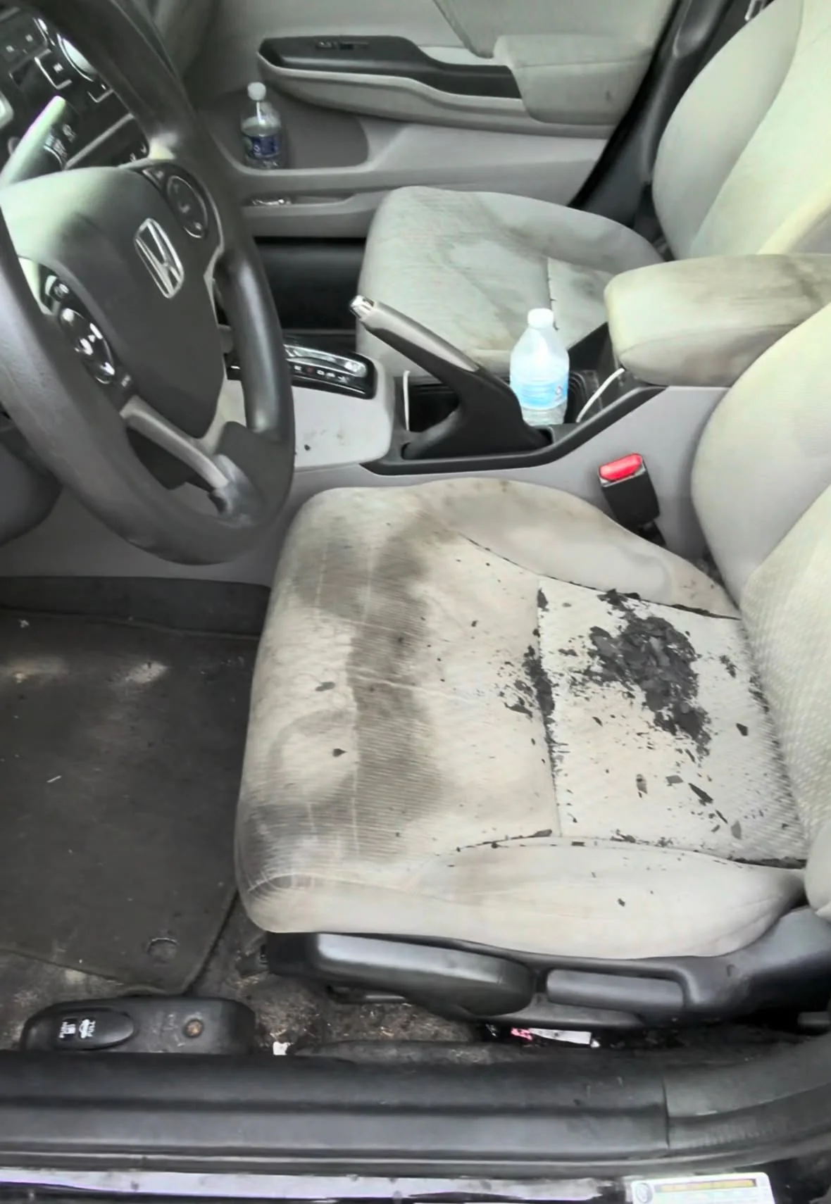 Heavily soiled Honda front interior before detailing